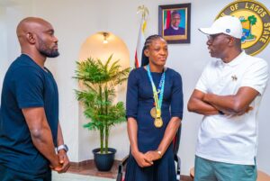 L-R: Head Coach of Nigeria Female Wrestling, Purity Akuh watches as Commonwealth Gold and World Wrestling Medalist, Odunayo Adekuoroye interacts with Lagos State Governor, Mr. Babajide Sanwo-Olu during a courtesy visit to the Governor, at Lagos House, Marina, on Tuesday, 16 August, 2022.