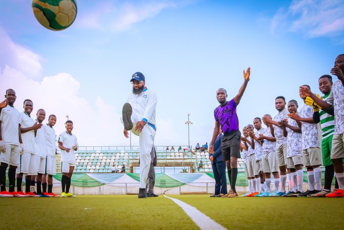 EVC kicks off ball The Executive Vice Chairman/CEO of the National Agency for Science and Engineering Infrastructure (NASENI), Mr. Khalil Suleiman Halilu (middle) kicks a ball to signal the opening of the NASENI Games 2025 at the MKO Abiola Stadium, Abuja yesterday.
